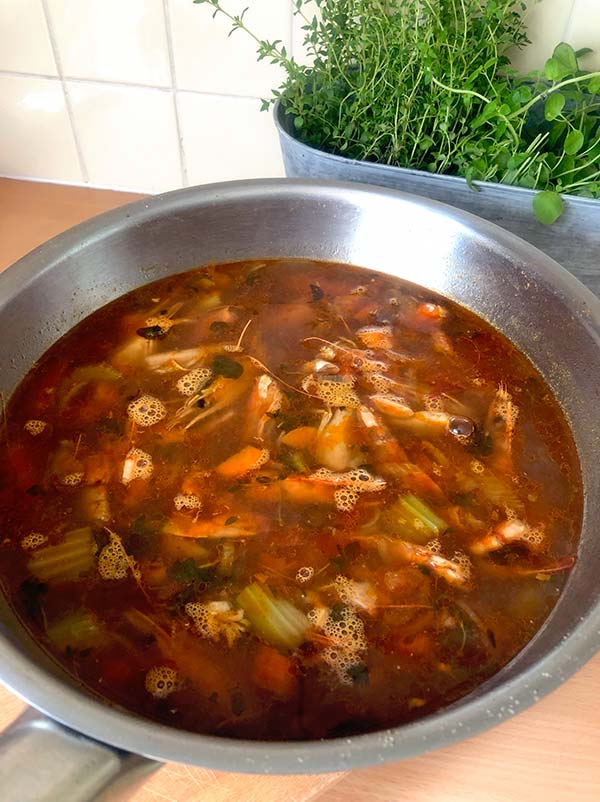 Prawn shells and vegetable broth ready to turn into a bisque