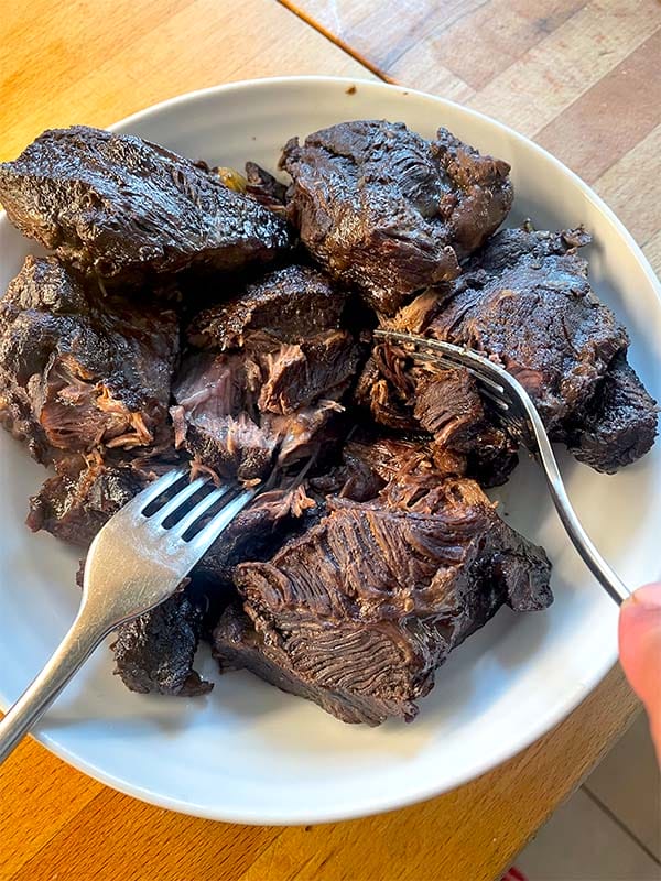 Shredding the beef cheeks