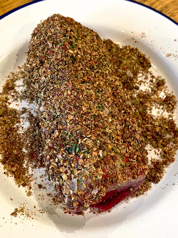 Beef carpaccio marinating in spice rub