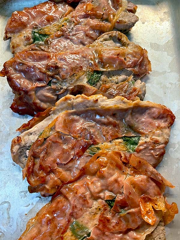 Pork tenderloins wrapped in Parma ham after frying
