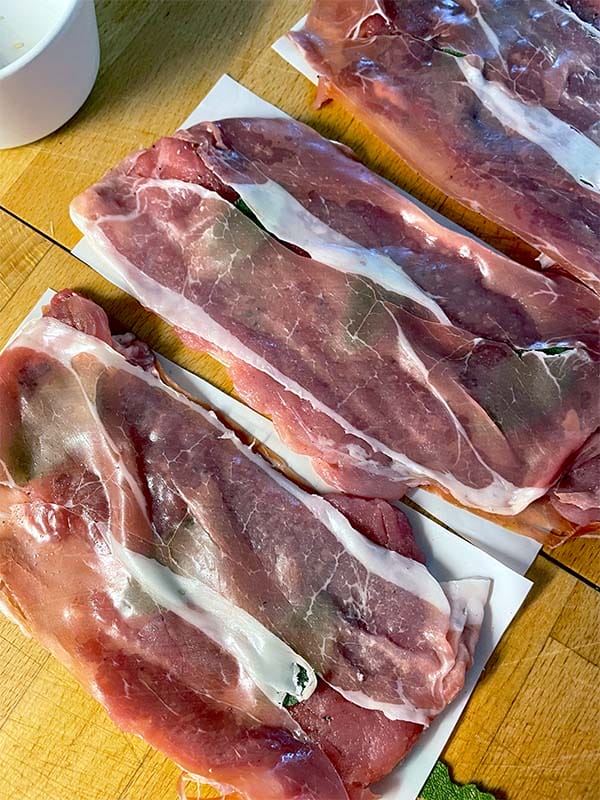 Pork tenderloins wrapped in Parma ham ready to pan fry