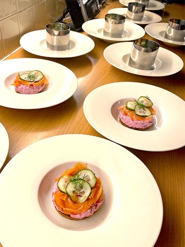 Beetroot ricotta smoked salmon on rye bread being prepared