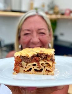 Jules holding a slice of lasagne